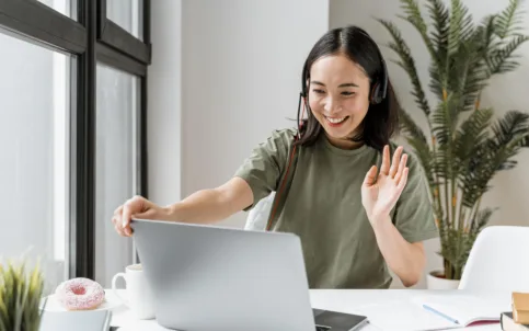 woman-with-headset-having-video-call-laptop