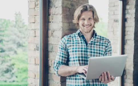 happy-blond-guy-posing-office-with-laptop-2