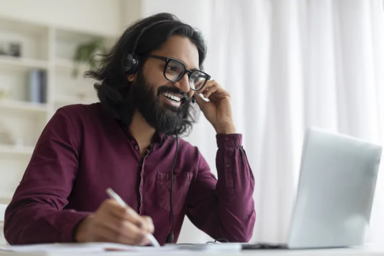 online-education-indian-smiling-man-headset-study-with-laptop-home