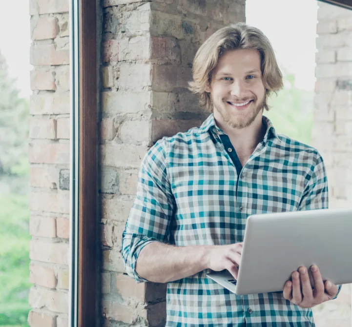 happy-blond-guy-posing-office-with-laptop-2