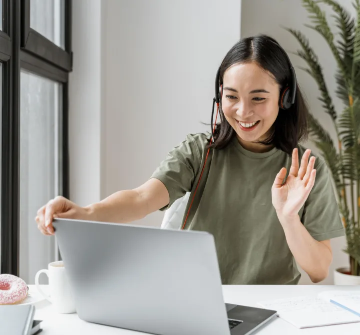 woman-with-headset-having-video-call-laptop