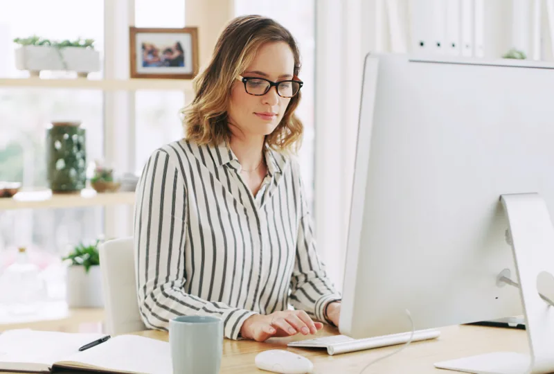 Business woman, company and computer for typing email with policy development, research or feedback. Desktop, reading and consultant in office to review project, compliance and check schedule online.