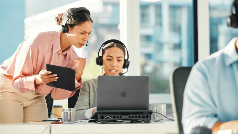 Call center, office training and women on computer for customer service, digital results and consultant feedback. Business agency or e commerce manager talking, support or advice on laptop and tablet
